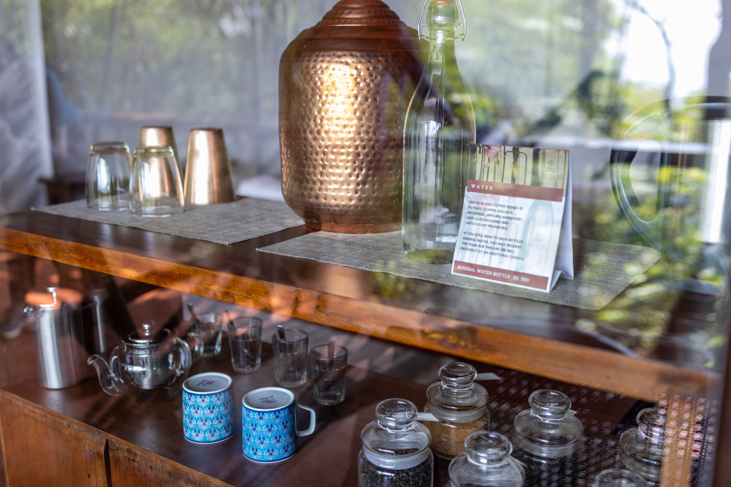 Copper water vessel and tea/coffee setup in rooms